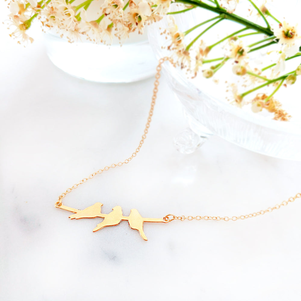 Three birds on a branch pendant necklace in gold