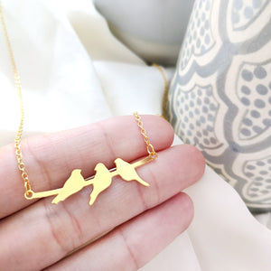 Three birds on a branch necklace in gold